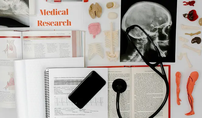 Medical research, books and tools laid out on a table