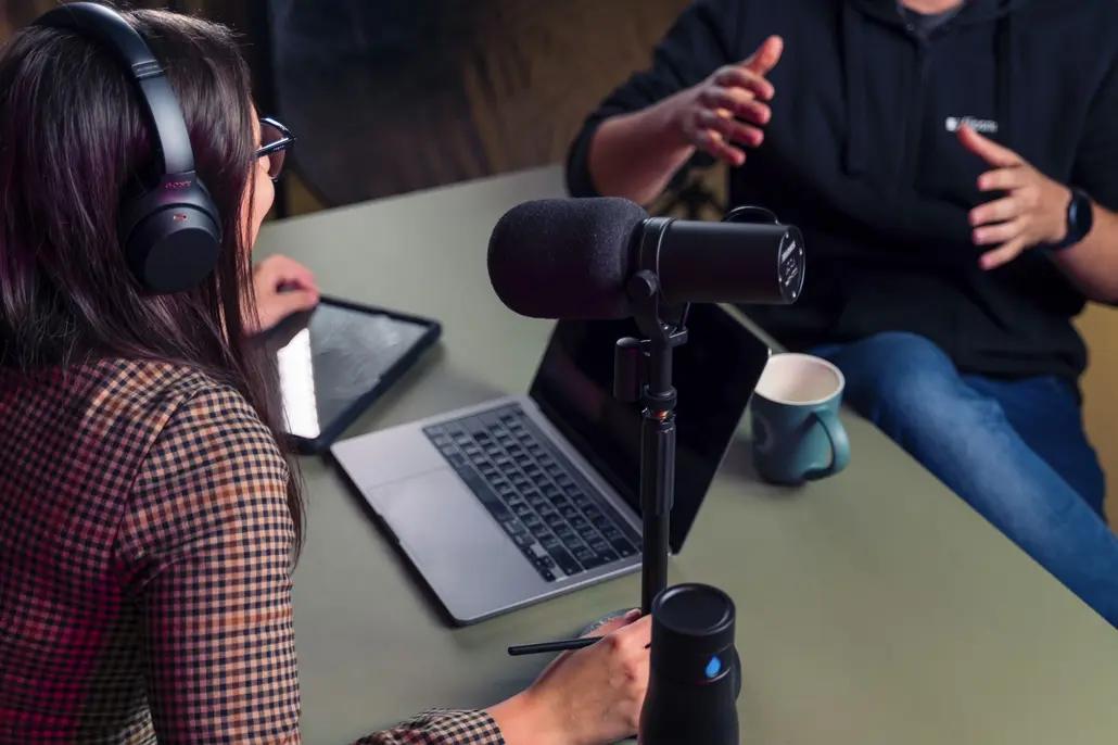Podcast hosts recording an episode in the studio